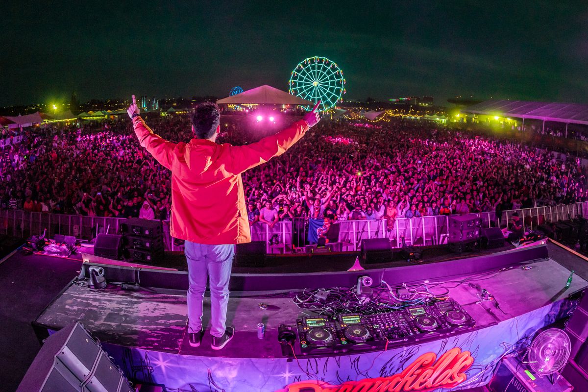 CHASER with arms up facing the Dreamfields crowd